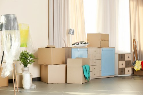 Removal team handling packed boxes safely during a house move