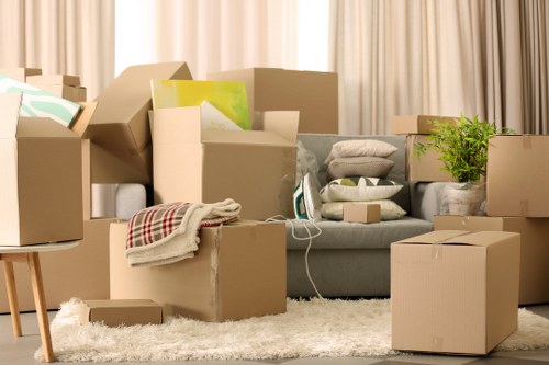 A moving team handling furniture during Saint Pancras removals in a city building