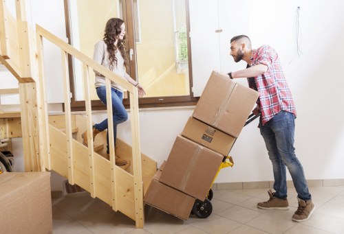 Staff using safe lifting methods during a relocation